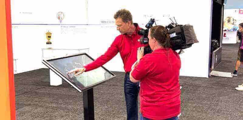 Camera operator filming interactive technology demonstration